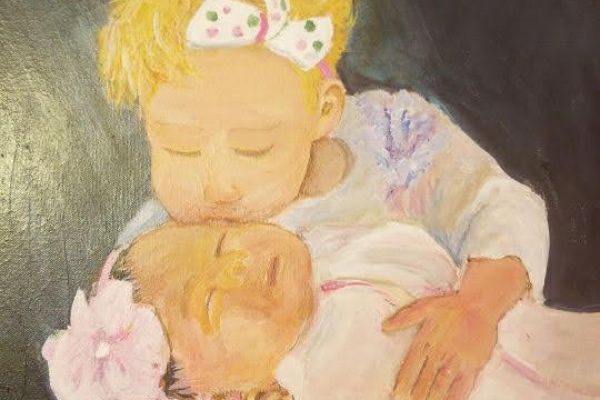Girl holding baby painting